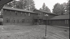 Hall House with bicycles parked outside and lamp in foreground.
