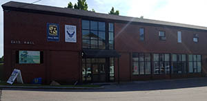 Zais Hall taken from fire station with ROTC banners hanging on exterior wall, July 2016.