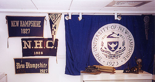 Collection of UNH banners hanging on wall