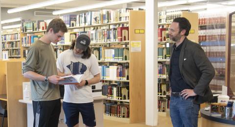 Students and librarian standing in EMCS Library