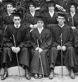 Seniors in cap and gown with class cane, 1916